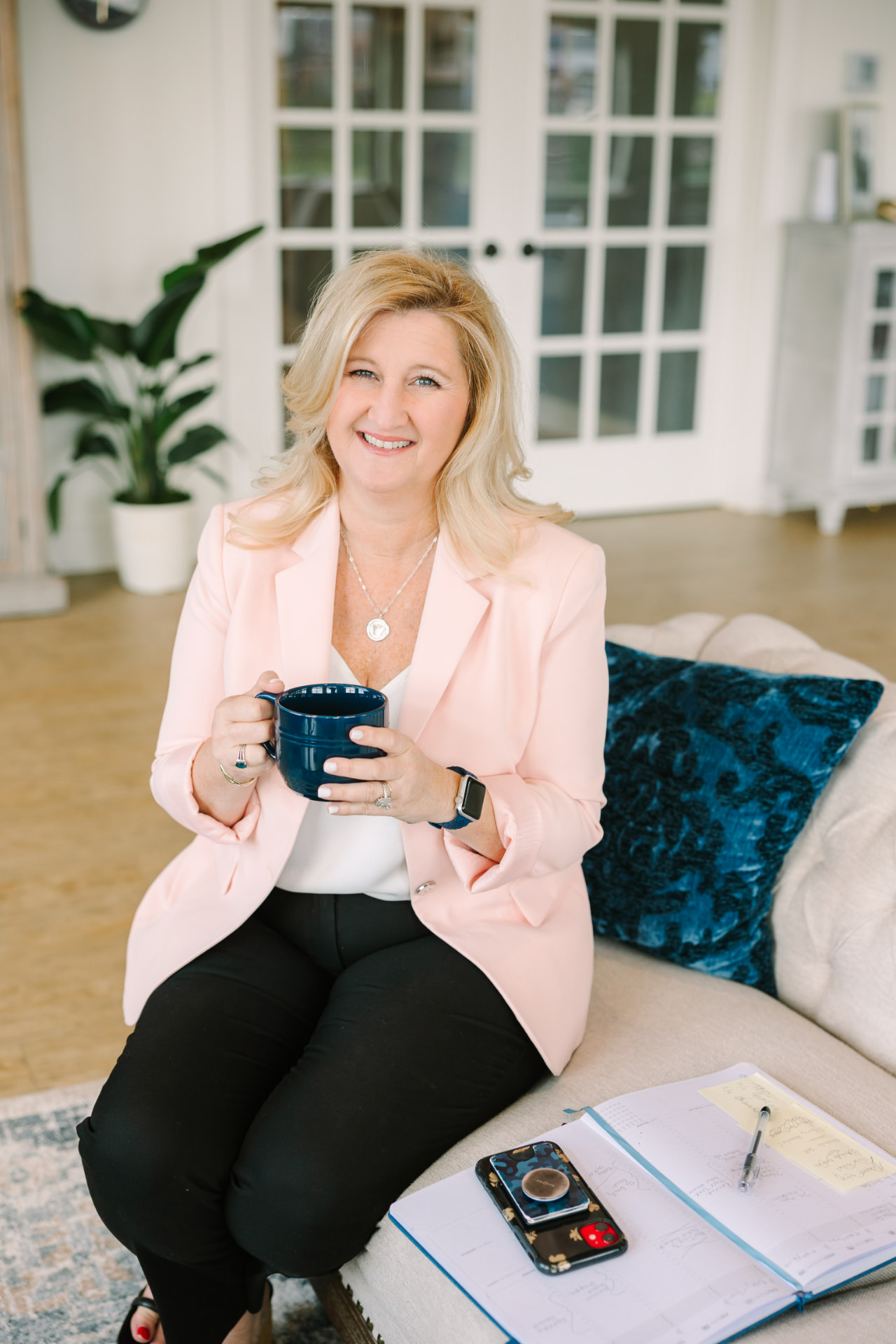Branding portrait of a woman seated in The Sapphire Suite lounge
