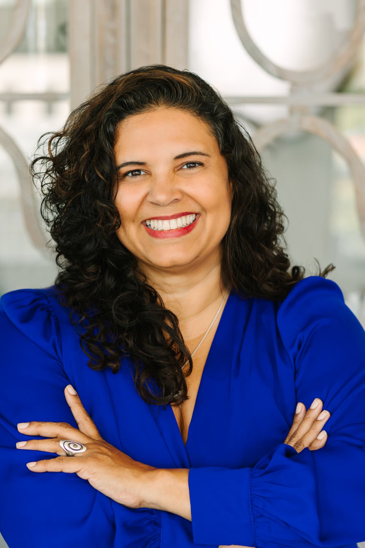Professional headshot of a woman in a cobalt blue blouse